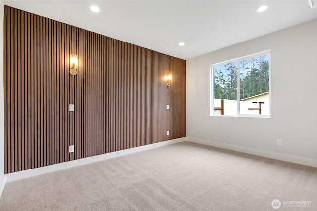 carpeted spare room featuring recessed lighting and baseboards