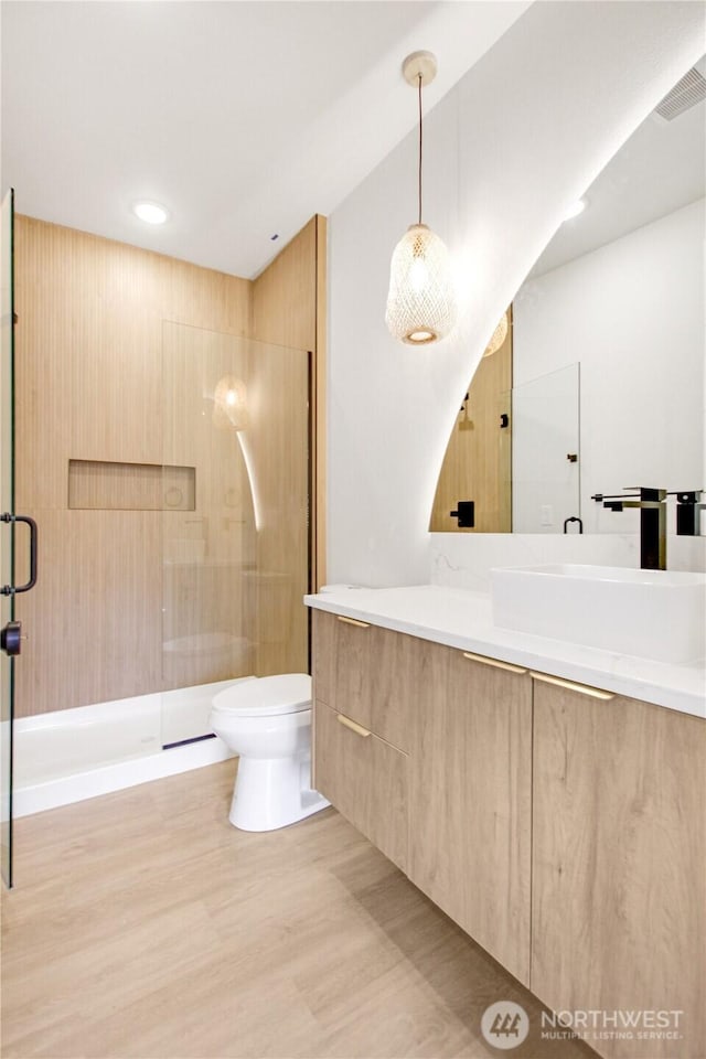 full bathroom featuring vanity, visible vents, recessed lighting, a stall shower, and toilet