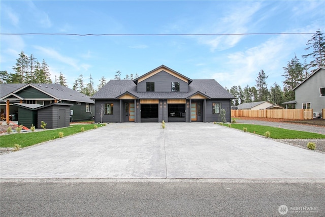 view of front of property with fence, driveway, roof with shingles, an attached garage, and a front lawn