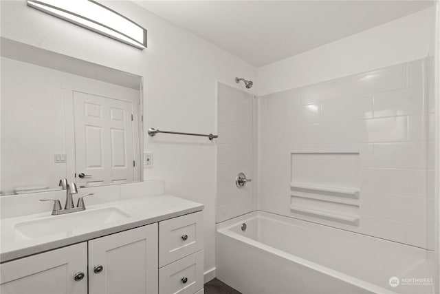 bathroom featuring vanity and tiled shower / bath