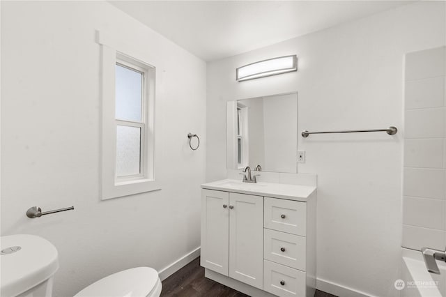 bathroom with vanity, toilet, and wood-type flooring