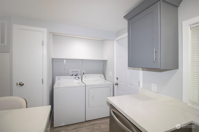 laundry room featuring light wood-type flooring and washing machine and dryer