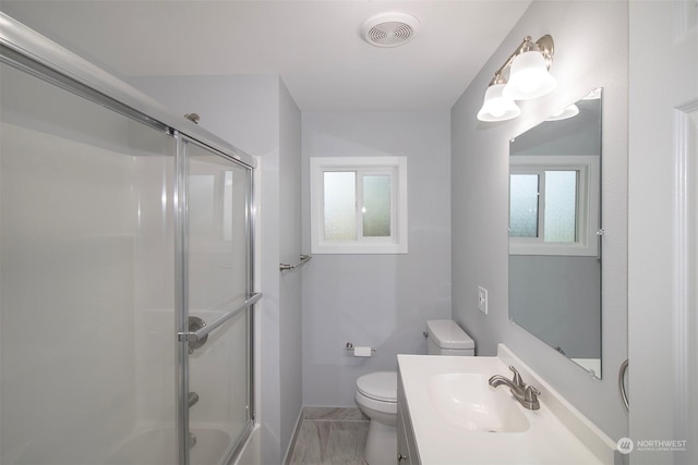 full bathroom with vanity, combined bath / shower with glass door, and toilet