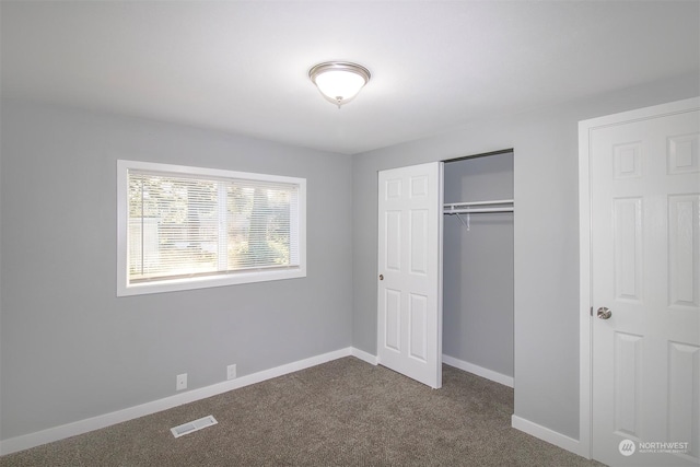 unfurnished bedroom with carpet floors and a closet