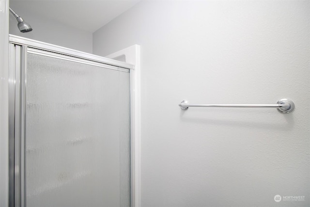 bathroom with a shower with shower door