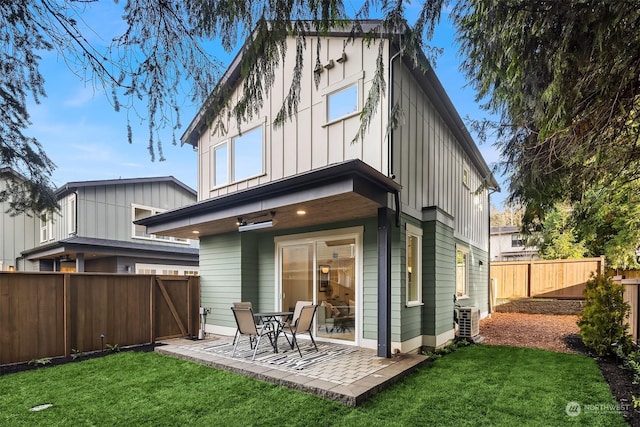 rear view of house featuring a yard and a patio area