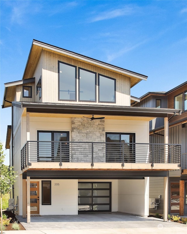 rear view of house with a balcony and ceiling fan