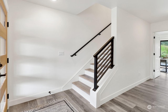 staircase featuring hardwood / wood-style floors