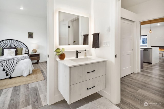 bedroom with hardwood / wood-style floors and sink