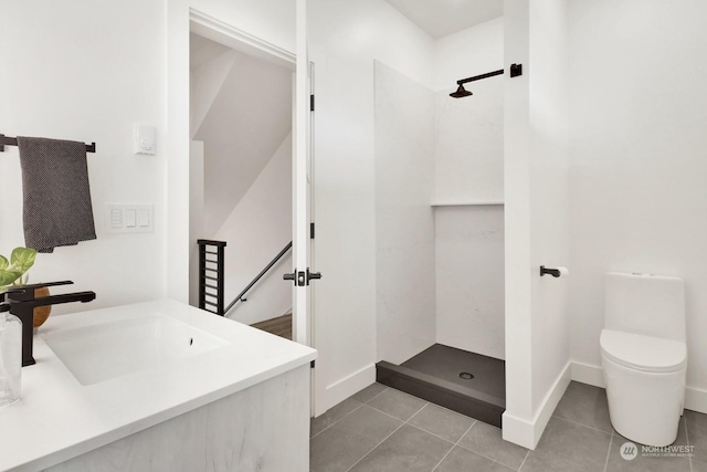 bathroom featuring a shower, tile patterned flooring, vanity, and toilet