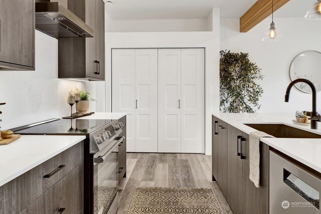 205 Riverwalk Dr, Lynden, WA 98264 - kitchen with stainless steel electric range oven, wall chimney exhaust hood, modern cabinets, light countertops, and light wood finished floors