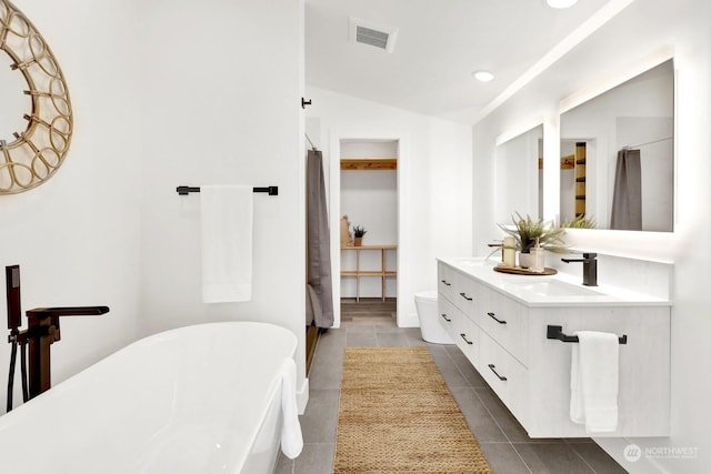 205 Riverwalk Dr, Lynden, WA 98264 - bathroom with vaulted ceiling, double vanity, a soaking tub, tile patterned floors, and recessed lighting