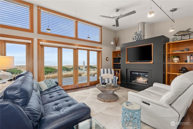 living room featuring french doors, a towering ceiling, and ceiling fan