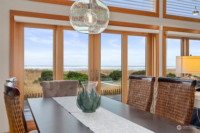 dining space with french doors, a water view, and plenty of natural light