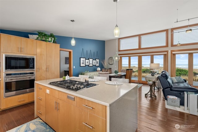 kitchen featuring pendant lighting, a center island, french doors, gas stovetop, and dark hardwood / wood-style flooring