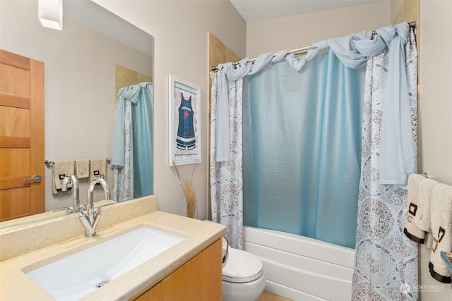 full bathroom with vanity, shower / bath combination with curtain, and toilet