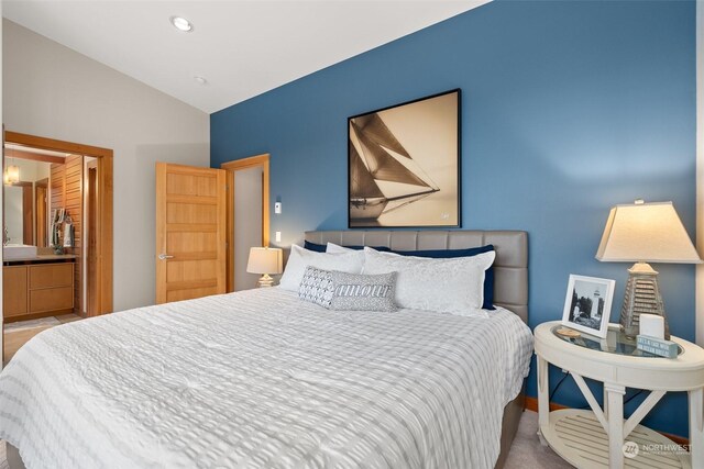 bedroom with vaulted ceiling and ensuite bath