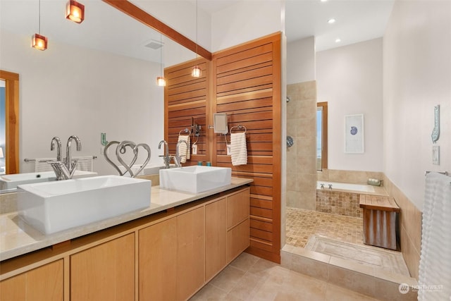 bathroom featuring tile patterned flooring, vanity, and independent shower and bath