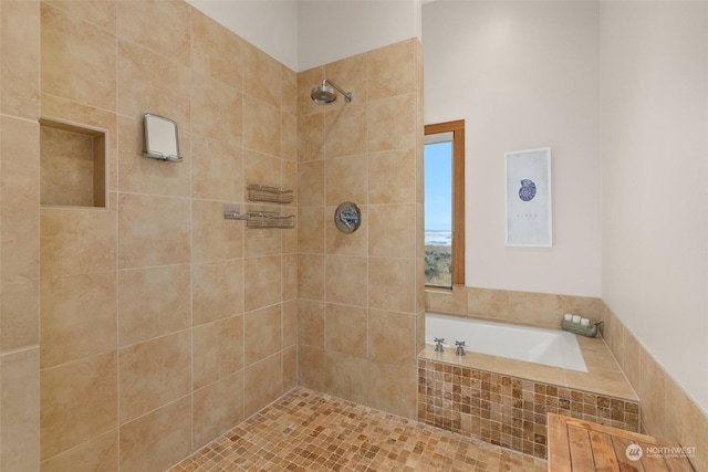 bathroom featuring shower with separate bathtub