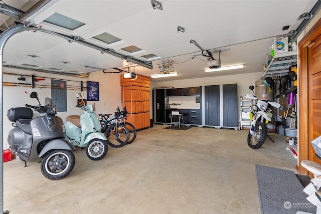 garage with electric panel and a garage door opener