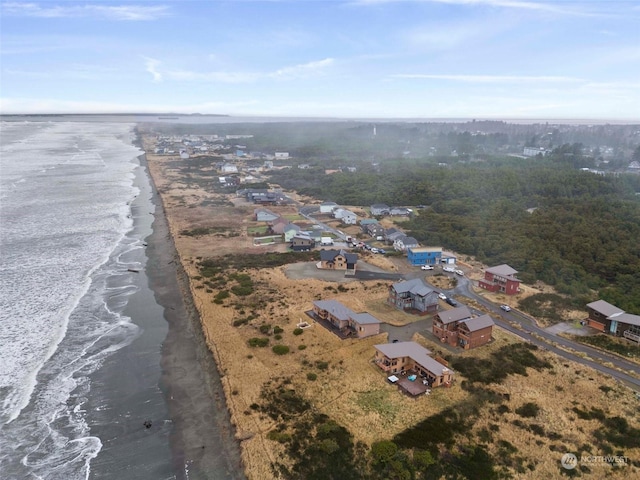 drone / aerial view with a water view and a beach view