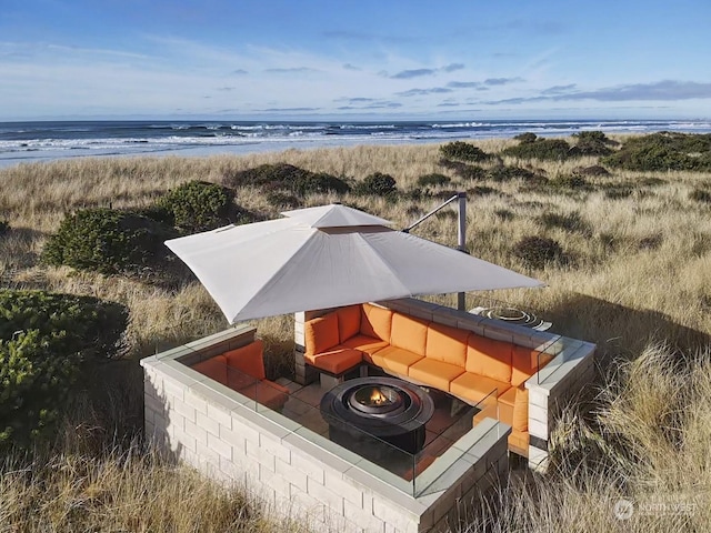 birds eye view of property featuring a water view and a view of the beach