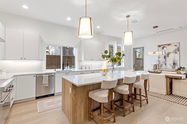 kitchen featuring white cabinetry, dishwasher, and a center island