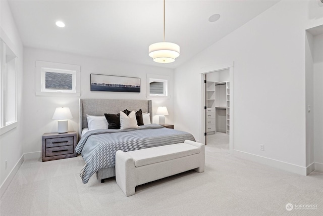 carpeted bedroom featuring a spacious closet, a closet, and vaulted ceiling