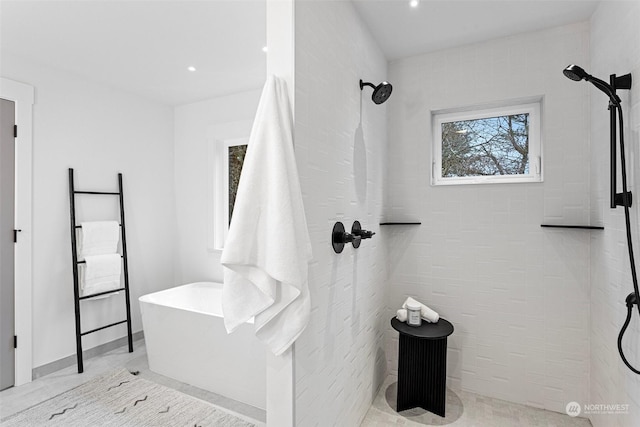 bathroom featuring shower with separate bathtub