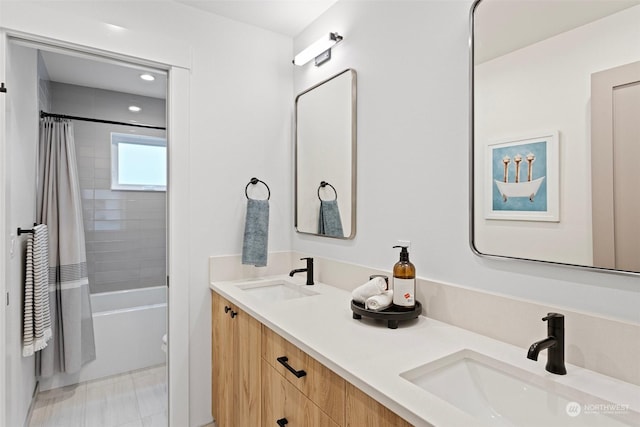 bathroom featuring vanity and shower / bathtub combination with curtain