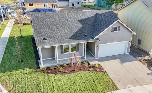 view of front facade with a front lawn, covered porch, and a garage