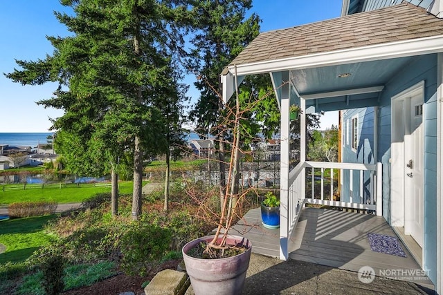 view of patio featuring covered porch and a water view