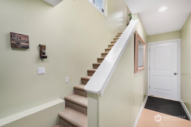 staircase featuring wood-type flooring