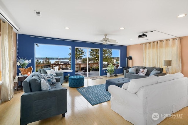 living room with ceiling fan and light hardwood / wood-style floors