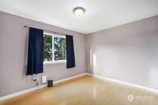 spare room with wood-type flooring