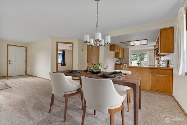 carpeted dining area featuring a notable chandelier