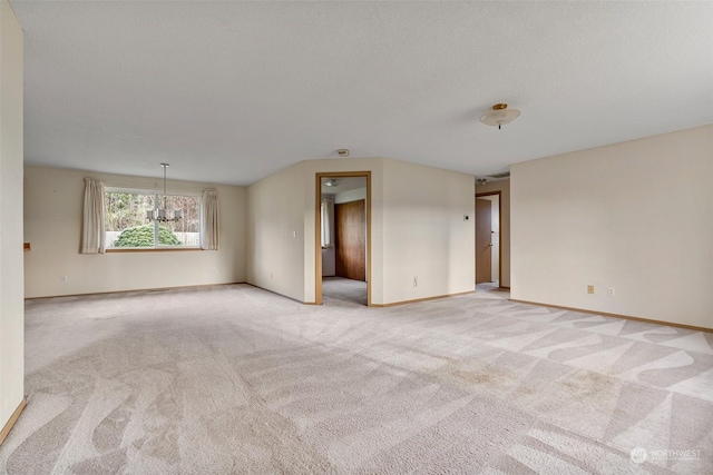 unfurnished room featuring light carpet