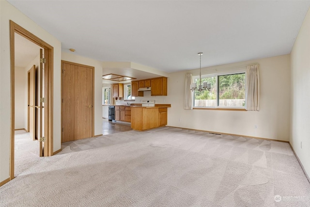 unfurnished living room with light colored carpet and an inviting chandelier