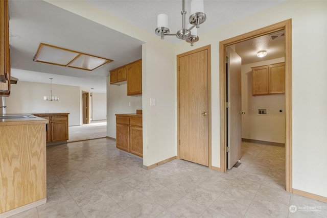 kitchen featuring sink, hanging light fixtures, and a chandelier