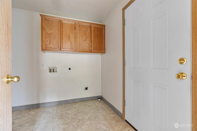 clothes washing area with hookup for a washing machine, cabinets, and hookup for an electric dryer