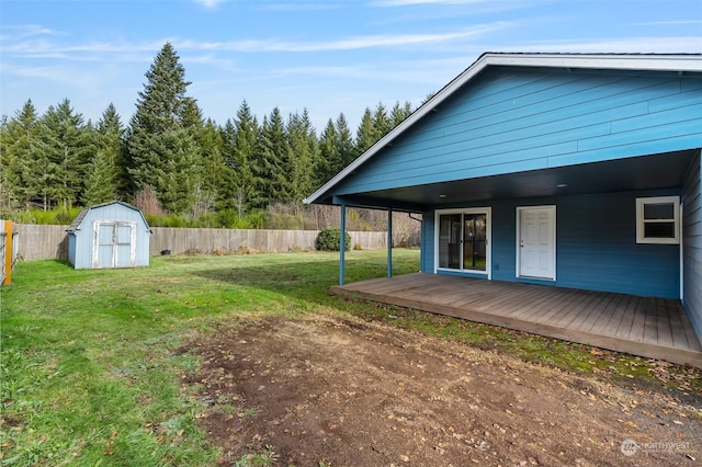 view of yard featuring a shed and a wooden deck