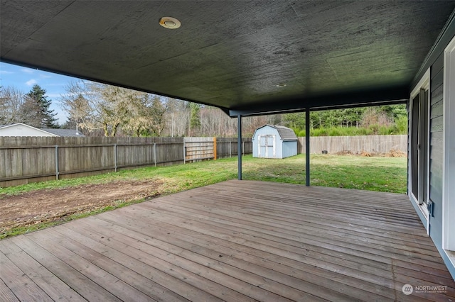 deck featuring a lawn and a shed