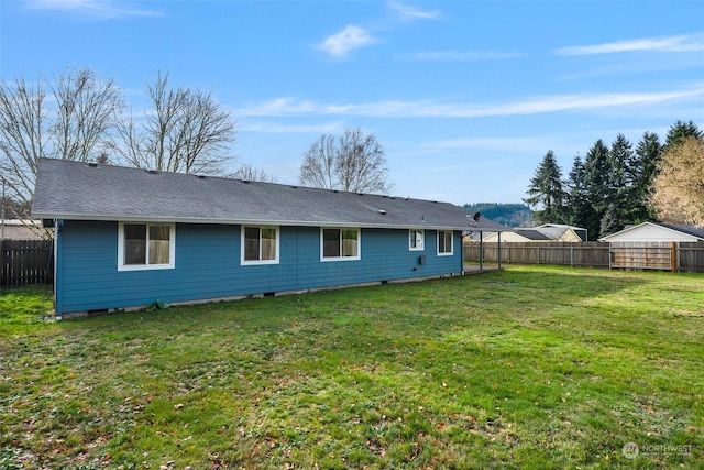 rear view of house featuring a yard