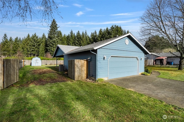 exterior space featuring a garage, a storage unit, cooling unit, and a lawn