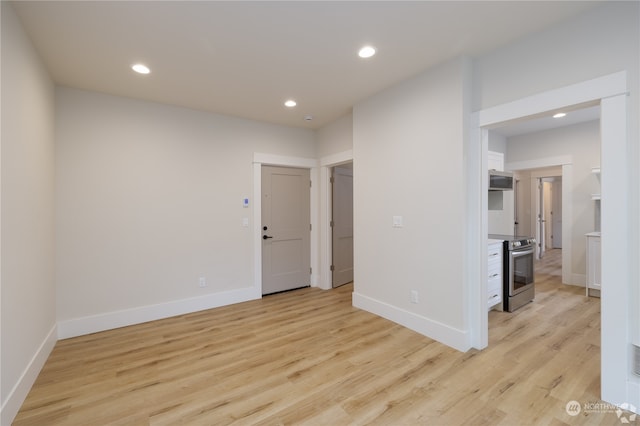 spare room featuring light hardwood / wood-style floors