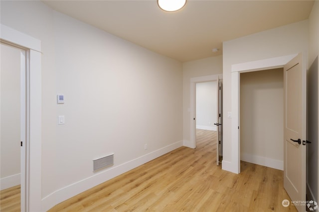 unfurnished bedroom featuring light wood-type flooring