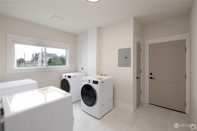 washroom with electric panel and washer and dryer