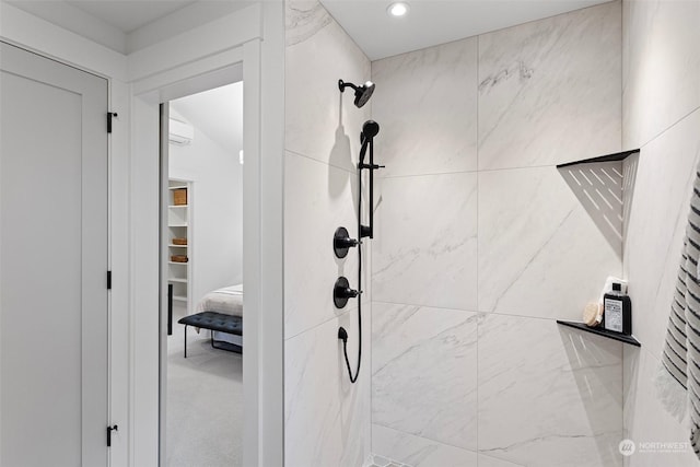 bathroom featuring a wall mounted air conditioner and a tile shower