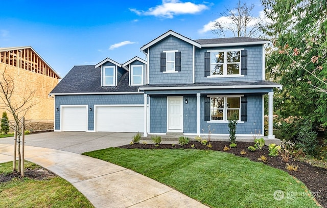 view of front of home with a garage and a front lawn