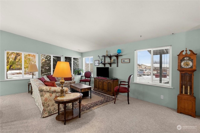 living room with lofted ceiling and carpet floors